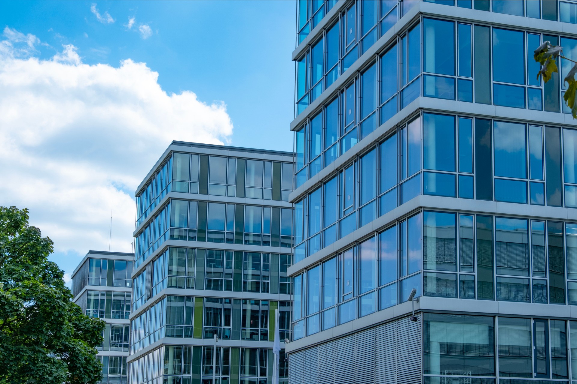 Multi-story modern glass buildings, residential and office, Vertical living meets corporate ambition, Concrete jungle, business district